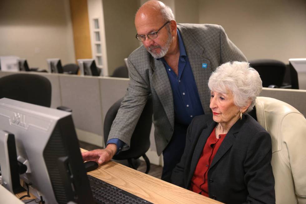 Carlos Rincon, left, partnership specialist for the United States Census Bureau, assists Christ ...