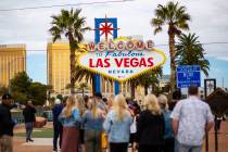 People line up to take photos by the "Welcome to Fabulous Las Vegas" sign in Las Vega ...