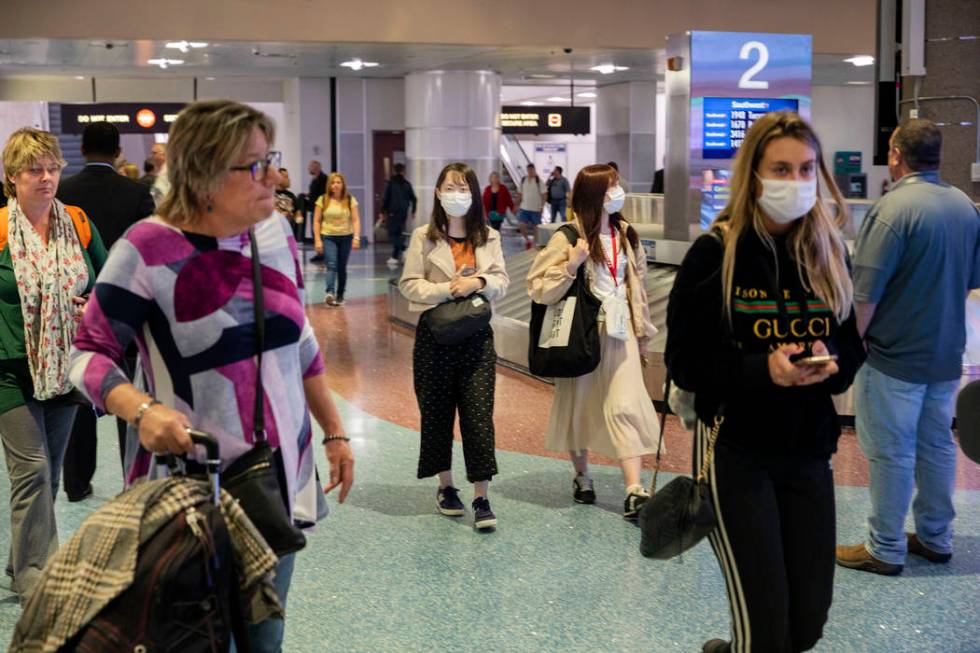 Passengers enter baggage claim at McCarran International Airport in Las Vegas on Thursday, Marc ...