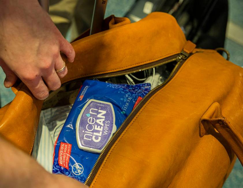 Passenger John Lewis of Georgia shows that the first thing in his luggage is sanitary wipes, at ...