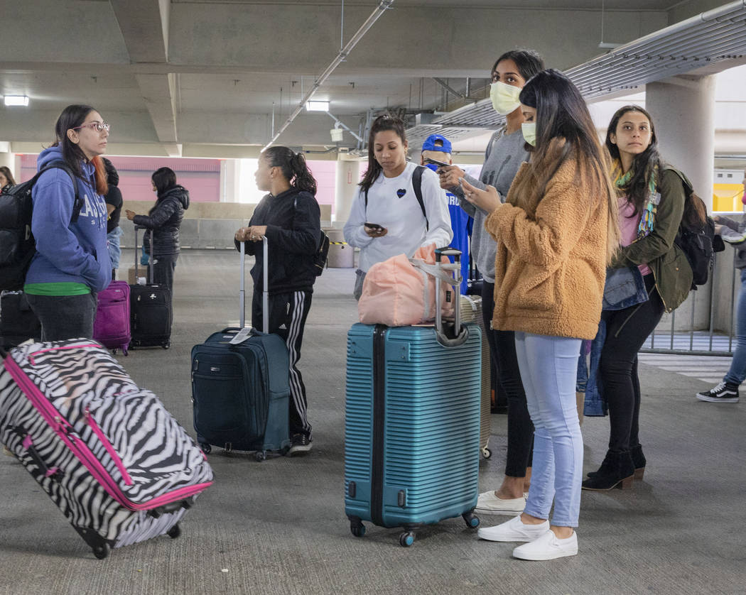 Passengers wait for the ride-hailing service at McCarran International Airport in Las Vega ...