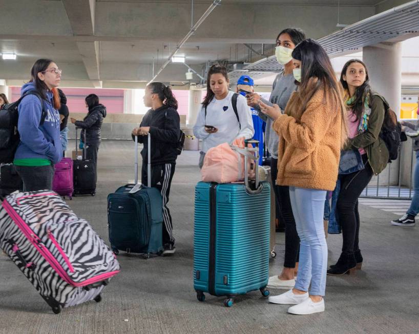 Passengers wait for the ride-hailing service at McCarran International Airport in Las Vega ...