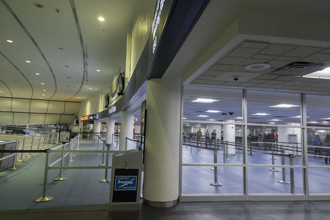 Passengers enter a security queue at McCarran International Airport in Las Vegas on Thursday, M ...