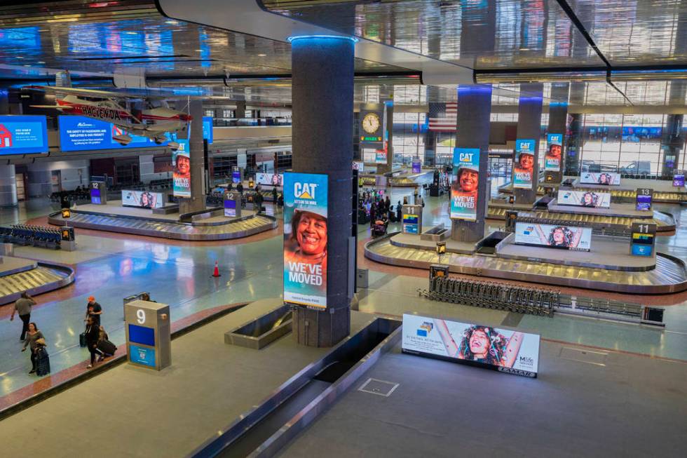 Passengers enter baggage claim at McCarran International Airport in Las Vegas on Thursday, Marc ...