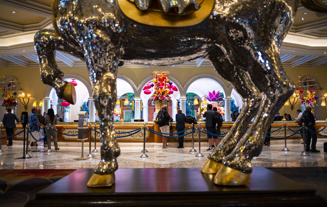 Visitors at the front desk at Bellagio in Las Vegas on Wednesday, March 11, 2020. (Chase Steven ...