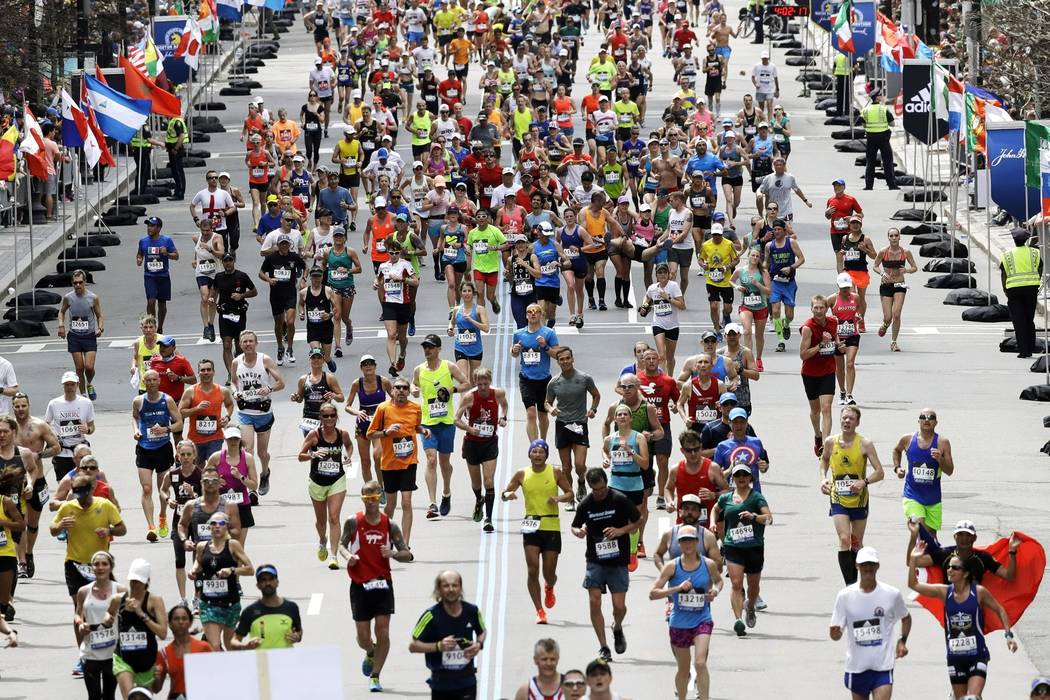 In this April 17, 2017, runners in the 121st Boston Marathon head down the stretch to the fini ...