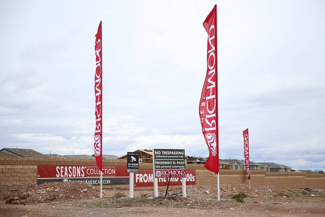 Flags wave for the Richmond American Chelsea Creek residential community in Las Vegas, Friday, ...