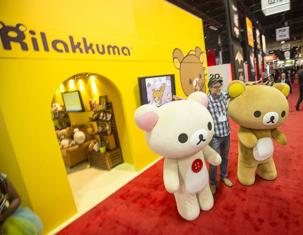 Greg Nuson poises for a photo with Rilakkuma cartoon characters during the Licensing Expo 201 ...