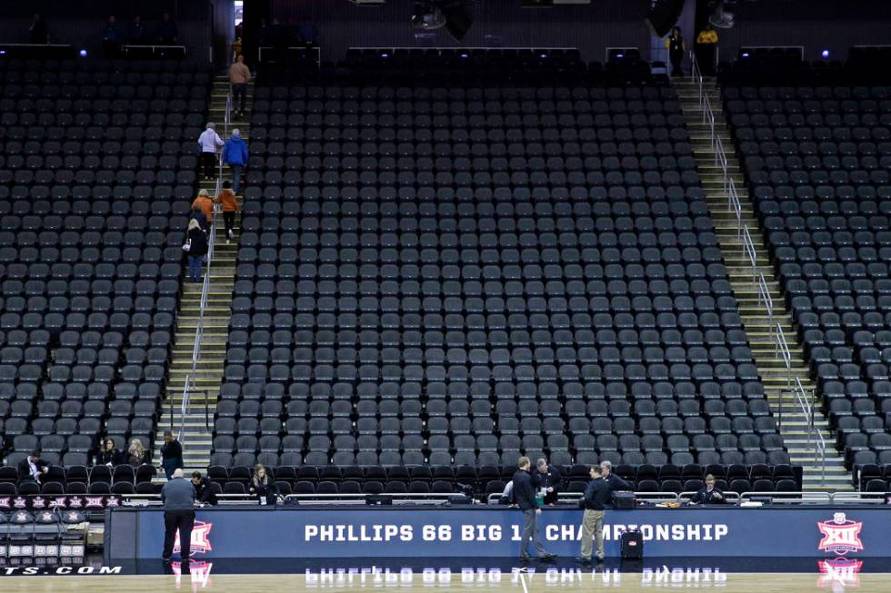 Fans leave the Sprint Center after the remaining NCAA college basketball games after in the Big ...