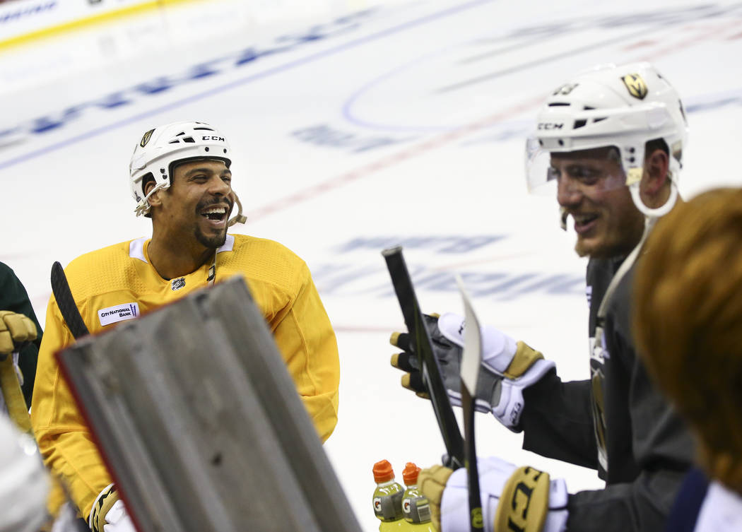 Golden Knights right wing Ryan Reaves (75) and defenseman Nate Schmidt (88) share a laugh while ...