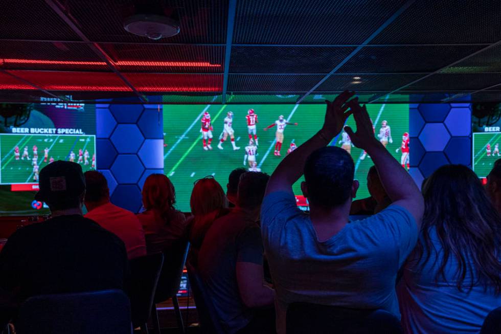 Individuals watch the NFL Super Bowl 54 football game between the San Francisco 49ers and Kansa ...