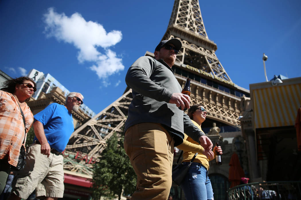 People walk on the Strip across from the Paris casino-hotel in Las Vegas, Saturday, March 14, 2 ...