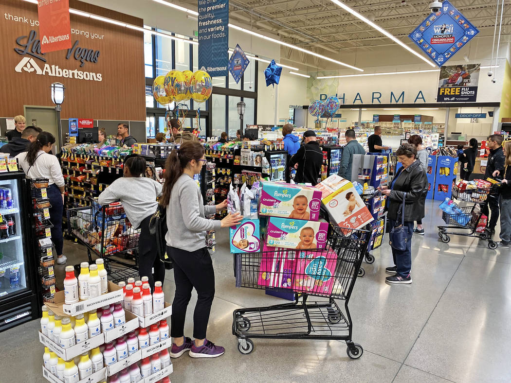 Shoppers wait in long lines at Albertsons at 6730 N Hualapai Way on Saturday, March 14, 2020, i ...