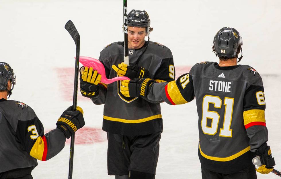 Vegas Golden Knights center Cody Glass (9) receives a pink flamingo from teammate right wing Ma ...