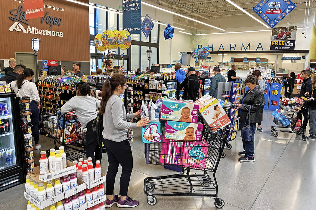 Shoppers wait in long lines at Albertsons at 6730 N Hualapai Way on Saturday, March 14, 2020, i ...