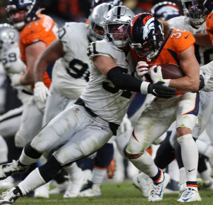 Oakland Raiders inside linebacker Will Compton (51) tackles Denver Broncos running back Phillip ...