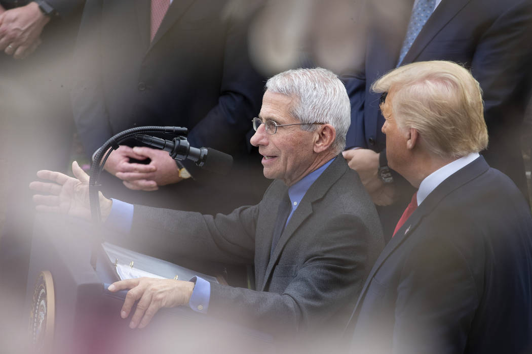 Dr. Anthony Fauci, director of the National Institute of Allergy and Infectious Diseases, left, ...