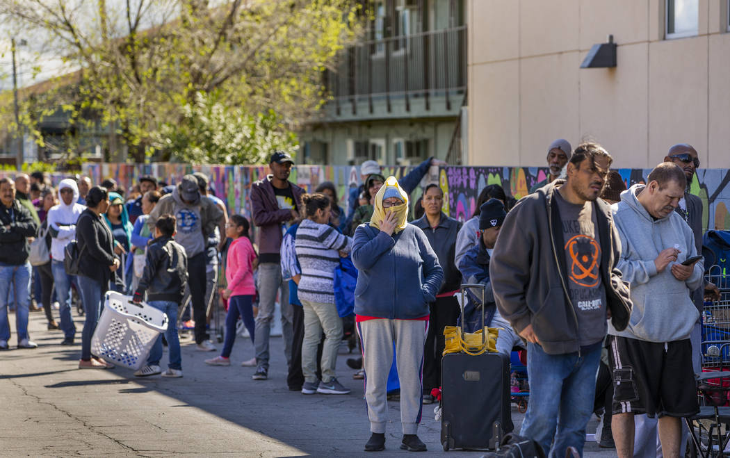 People line up at SHARE Village Las Vegas on Saturday, March 14, 2020, in Las Vegas. (L.E. Bask ...