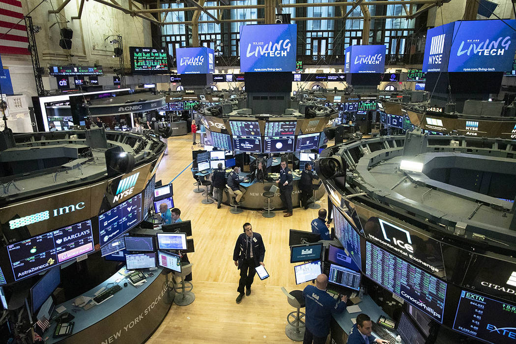 A trader walks on the floor of the New York Stock Exchange in New York. (AP Photo/Mark Lennihan)