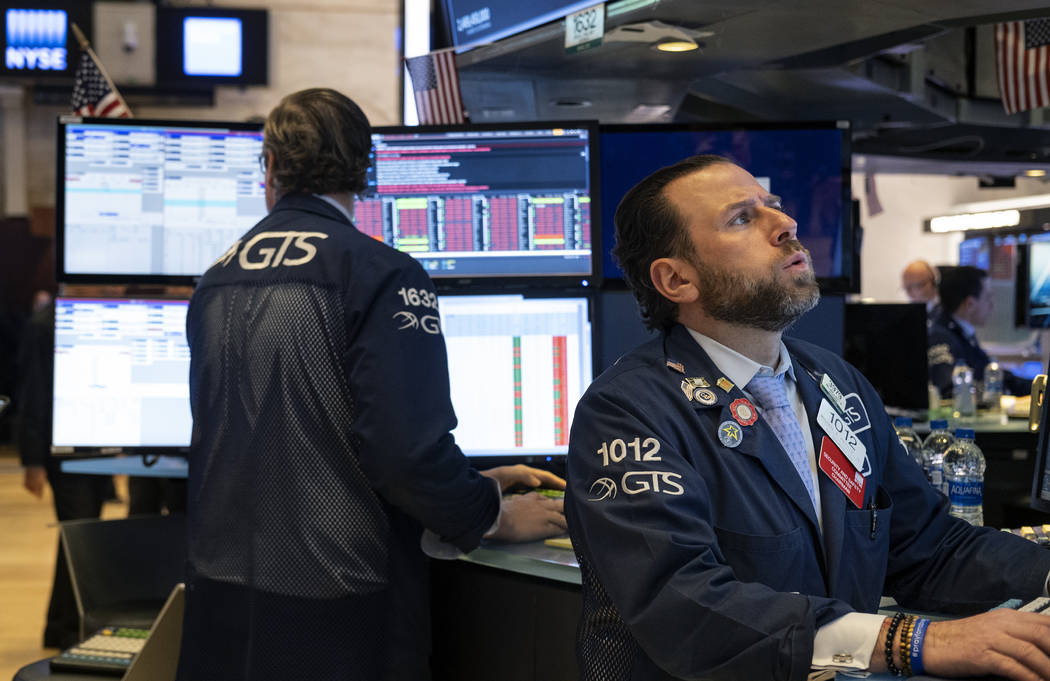 Trader Peter Tuchman works on the floor of the New York Stock Exchange Monday, March 16, 2020. ...