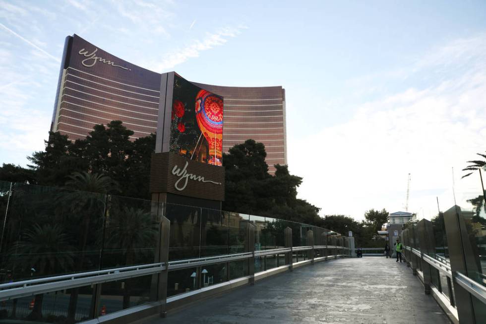 A woman sweeps a pedestrian bridge to the Wynn in Las Vegas on Monday, March 16, 2020. (Elizabe ...