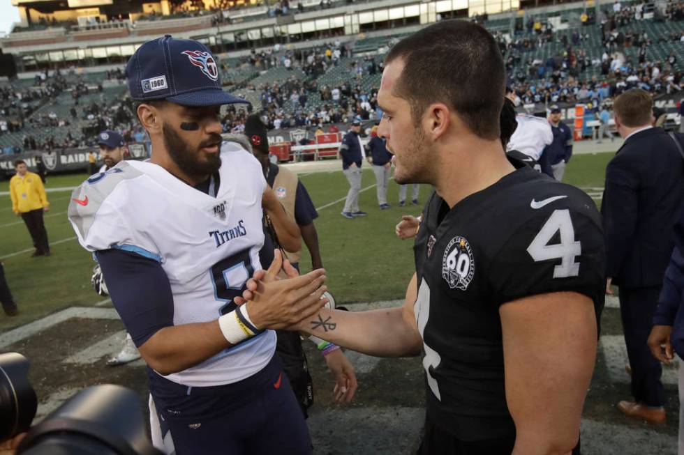 Tennessee Titans quarterback Marcus Mariota, left, greets Oakland Raiders quarterback Derek Car ...