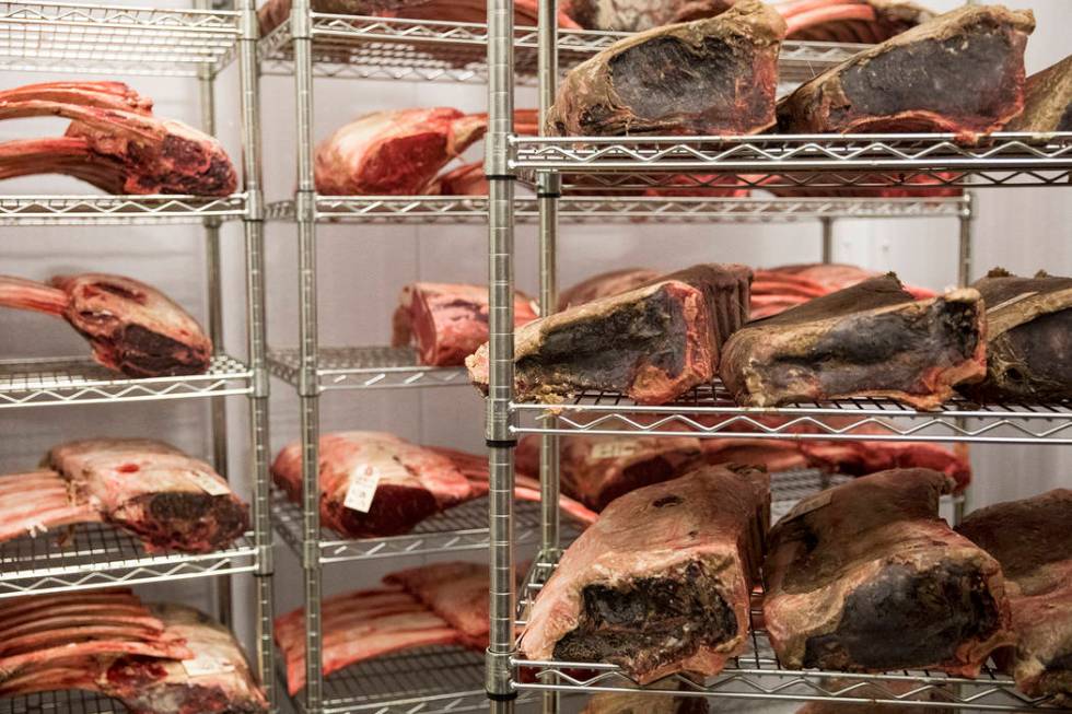 Meats that can no longer be sold to restaurants closed because of concerns of COVID-19 line the ...