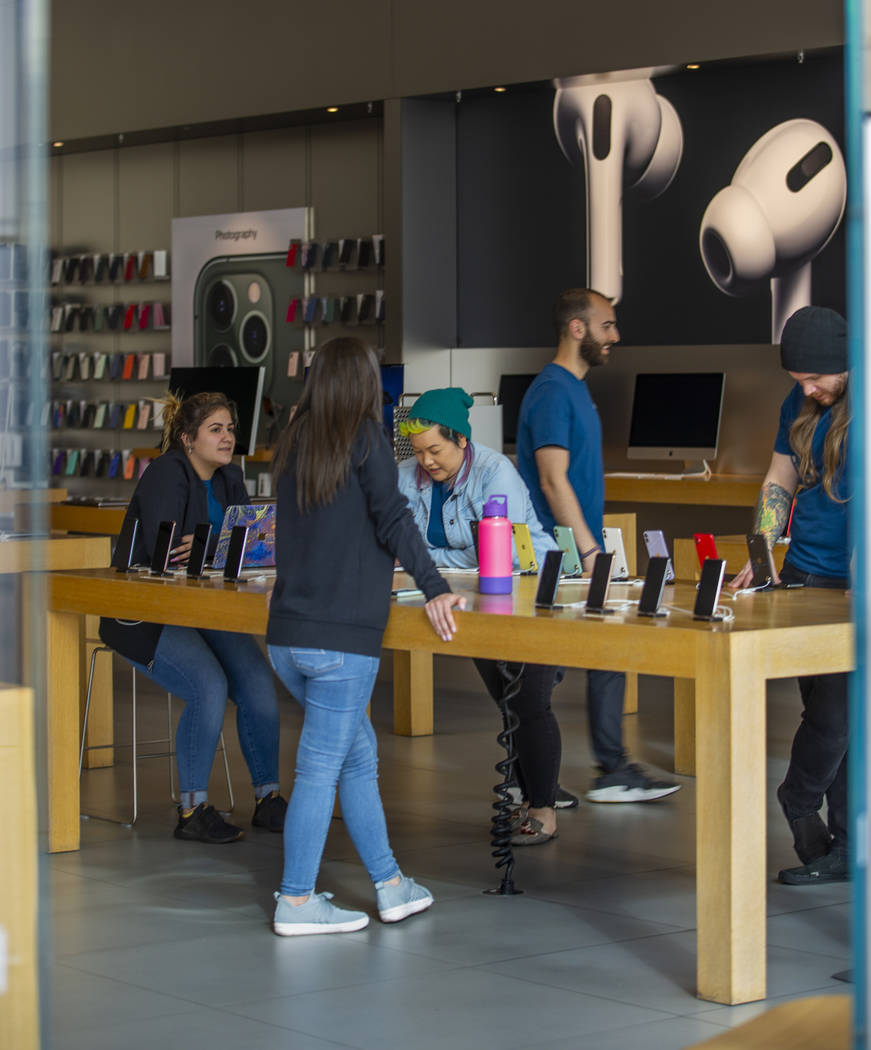 Apple Store employees wrap up things as their store is now closed until March 27th at Downtown ...