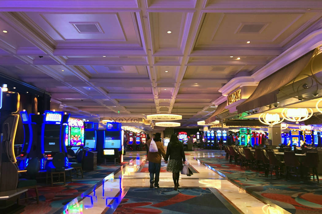A couple wanders through the gaming area at the Bellagio on Tuesday, March 17, 2020, in Las Veg ...
