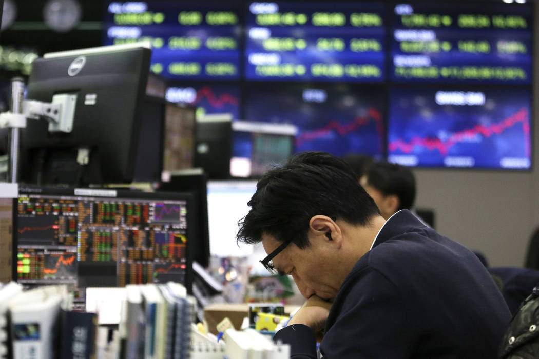 A currency trader drops his head at the foreign exchange dealing room of the KEB Hana Bank head ...