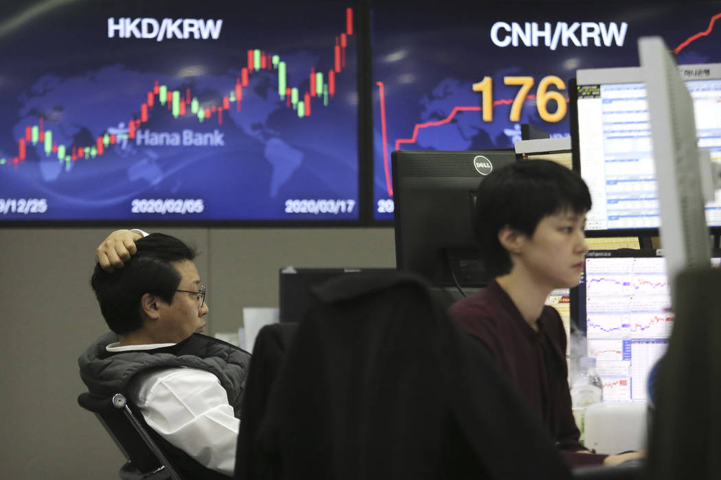 Currency traders watch monitors at the foreign exchange dealing room of the KEB Hana Bank headq ...