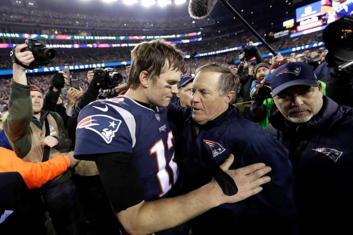 FILE - In this Jan. 21, 2018, file photo, New England Patriots quarterback Tom Brady, left, hug ...