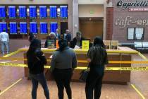 Courthouse visitors stand behind police tape around the information desk at the Regional Justic ...