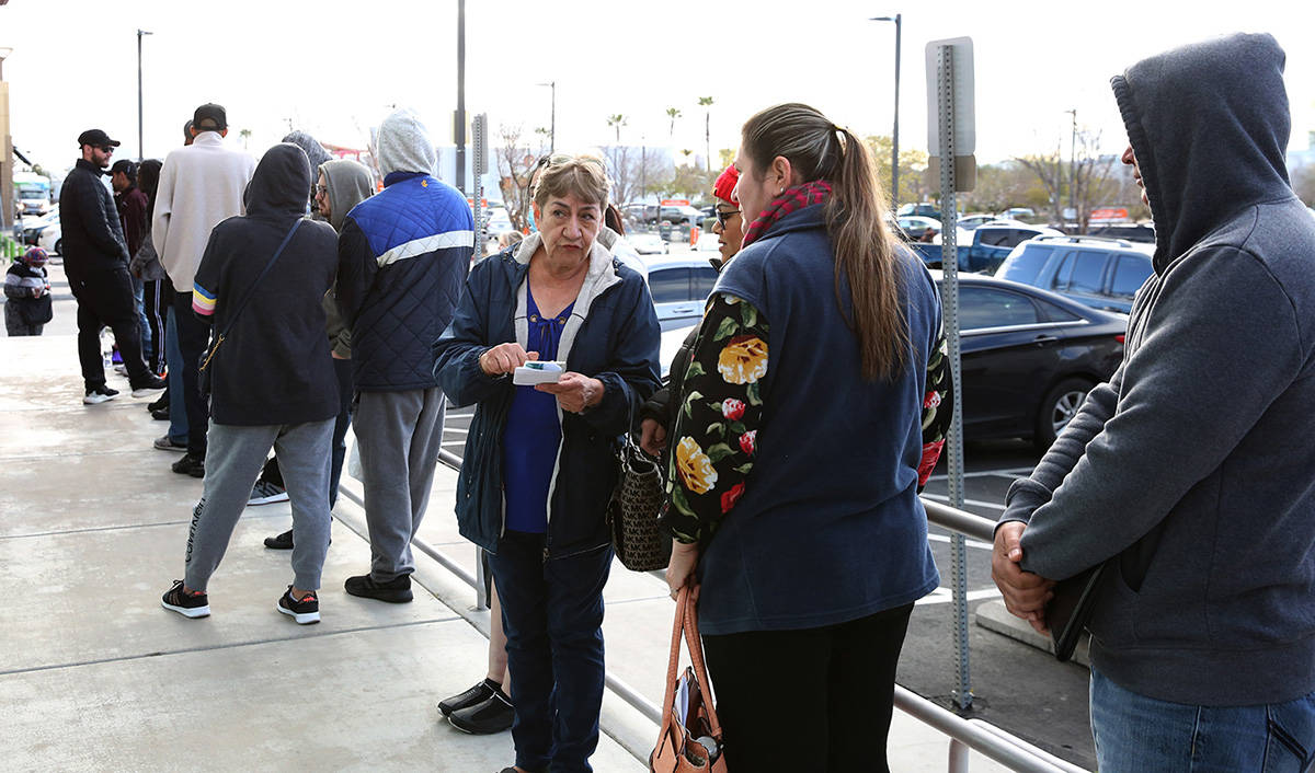 People wait in line at One-Stop Career Center on Tuesday, March 17, 2020, in Las Vegas. (Bizuay ...