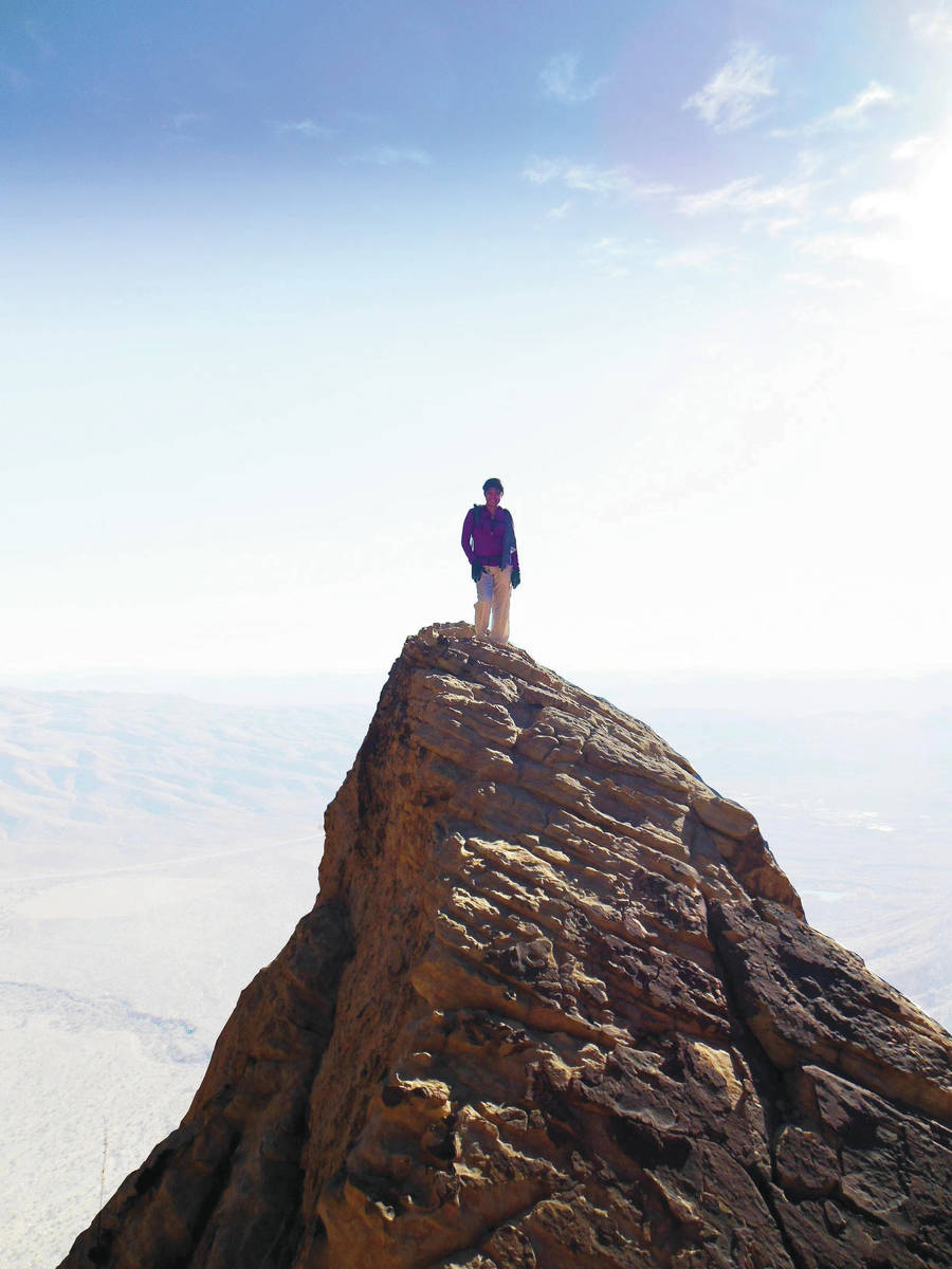 Tee Gammon stands on top of White Rock Pinnacle, also knows as White Pinnacle Peak, in Red Rock ...