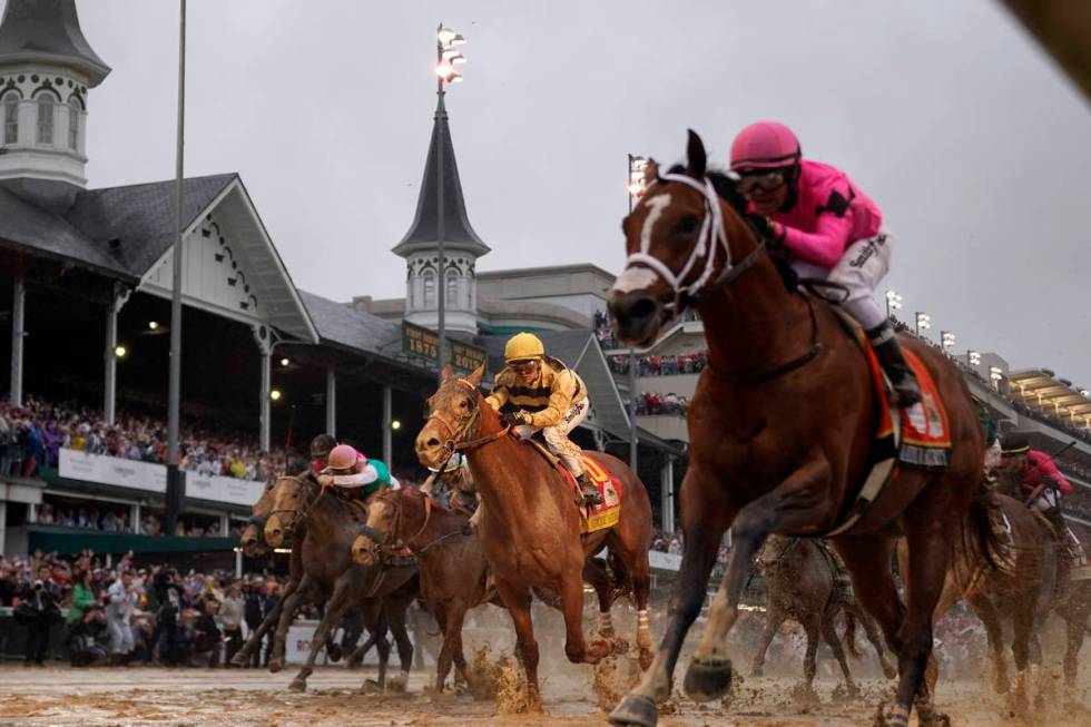 Luis Saez rides Maximum Security, right, across the finish line first against Flavien Prat on C ...