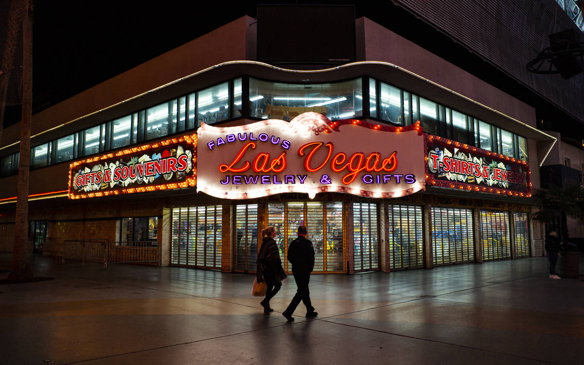 People walk past the closed Fabulous Las Vegas Jewelry & Gifts store at the Fremont Street Expe ...