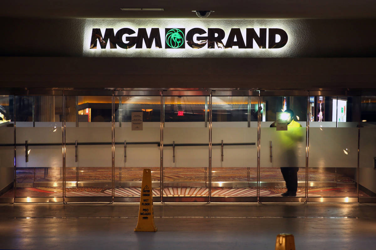 A security guard patrols inside the outer doors of the MGM Grand as nonessential business closu ...
