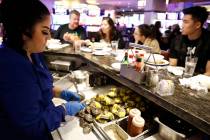 Server Brenda Guerrero shucks oysters at Oyster Bar at Palace Station hotel-casino on Saturday, ...