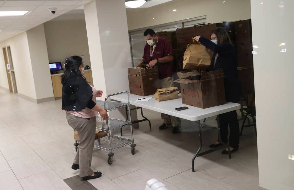 Hospital workers organize meals from Piero's Italian Cuisine that were delivered to S ...