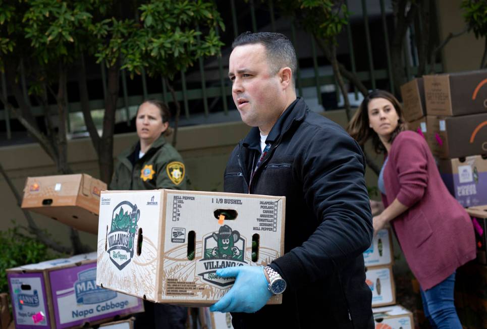 Officer Marc Viskoc helps stage a food donation from MGM Resorts outside the Las Vegas Metropol ...