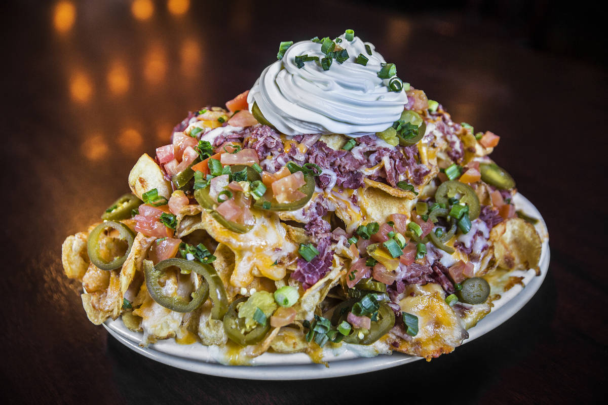 McMullan's Irish nachos with shredded corn beef, homemade potato chips, layered cheddar cheese, ...