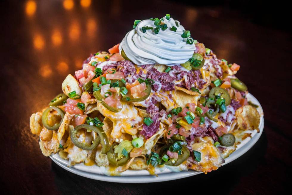 McMullan's Irish nachos with shredded corn beef, homemade potato chips, layered cheddar cheese, ...