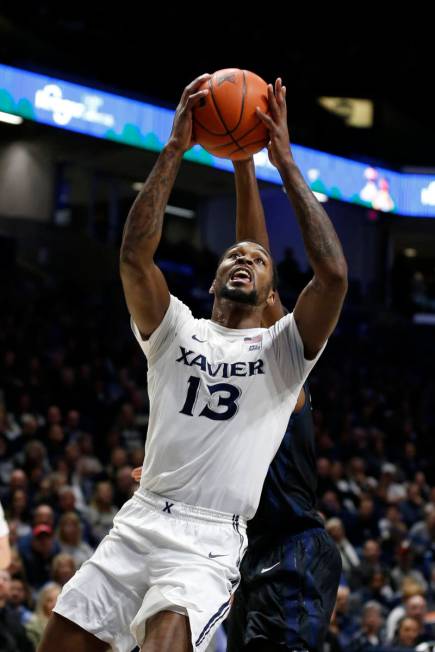 Xavier forward Naji Marshall (13) shoots against Butler during the first half of an NCAA colleg ...