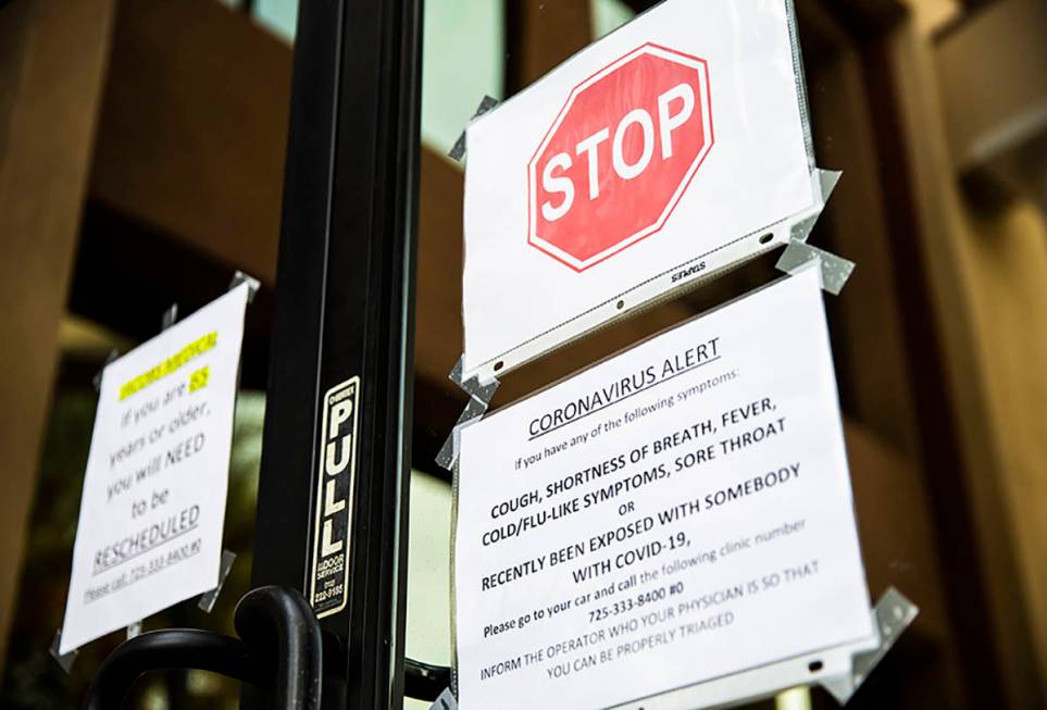 A sign on the door of primary care physician Dr. Loring Jacobs office in Henderson directing pa ...