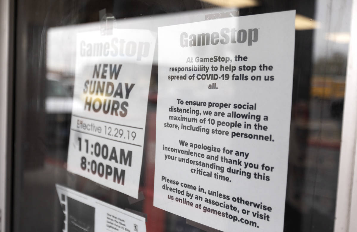 A sign indicates GameStop's COVID-19 prevention efforts on the door of the store at 2119 East L ...