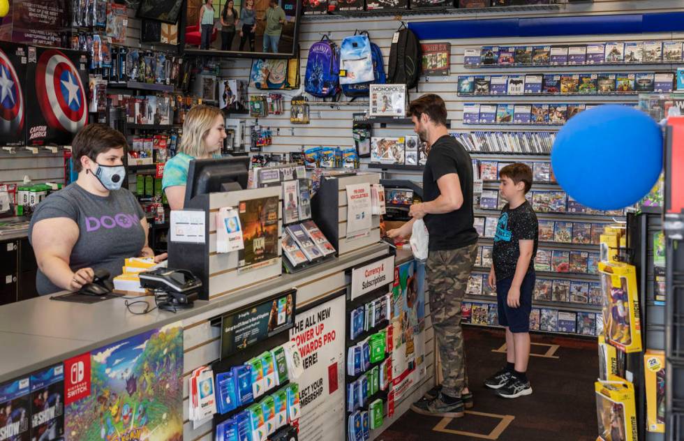 Customers purchase items at the GameStop store at 947 South Rainbow Boulevard in Las Vegas whil ...