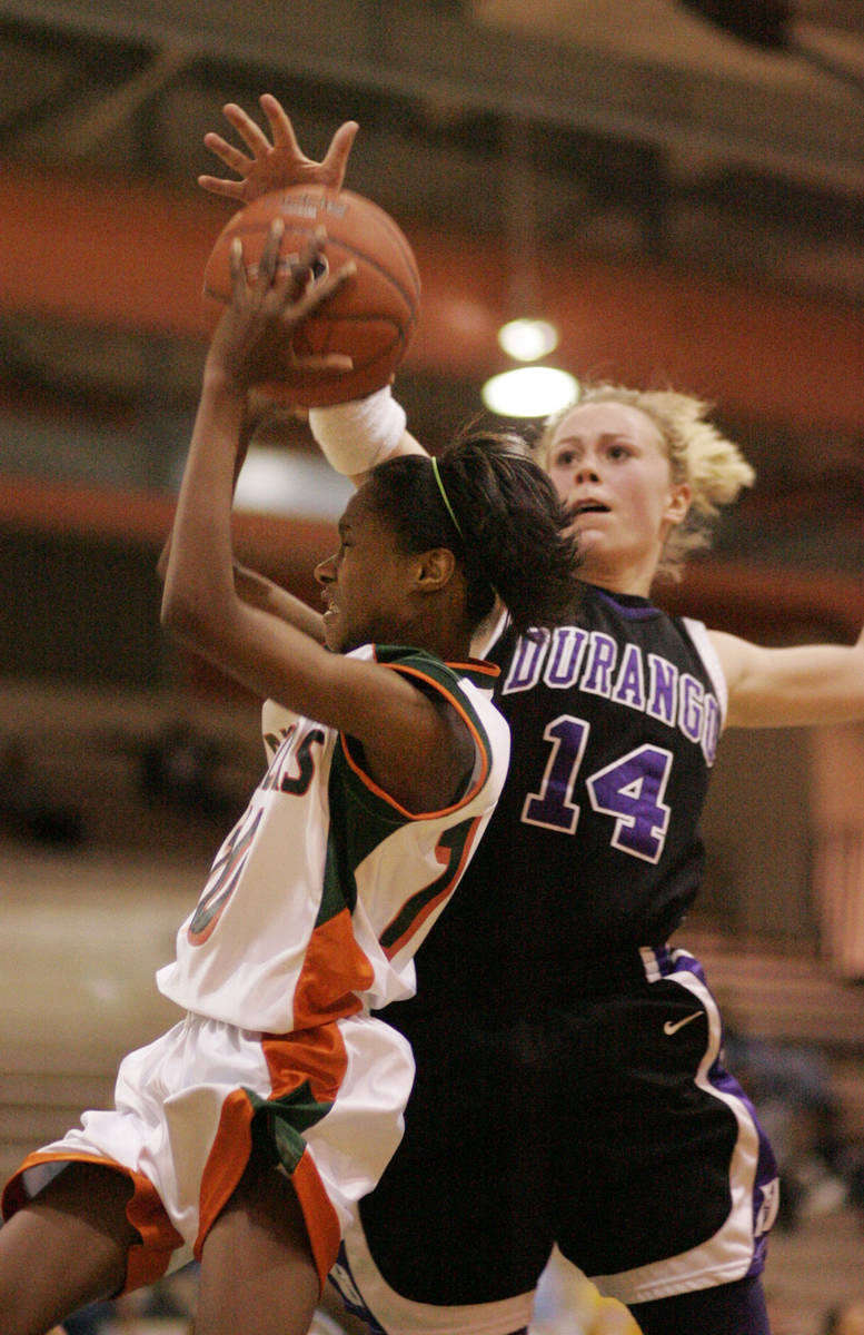 Lindy La Rocque of Durango High School, right, goes up to block Chelsea Hopkins of Mojave High ...