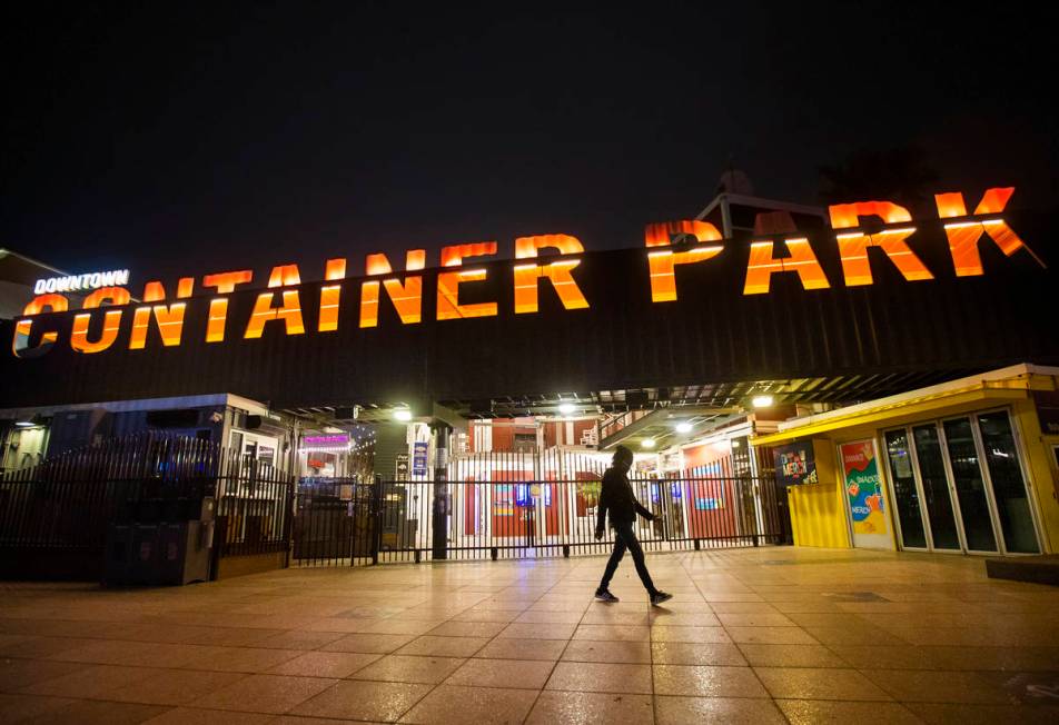 A single pedestrian passes Container Park in downtown Las Vegas, which is closed due to concern ...