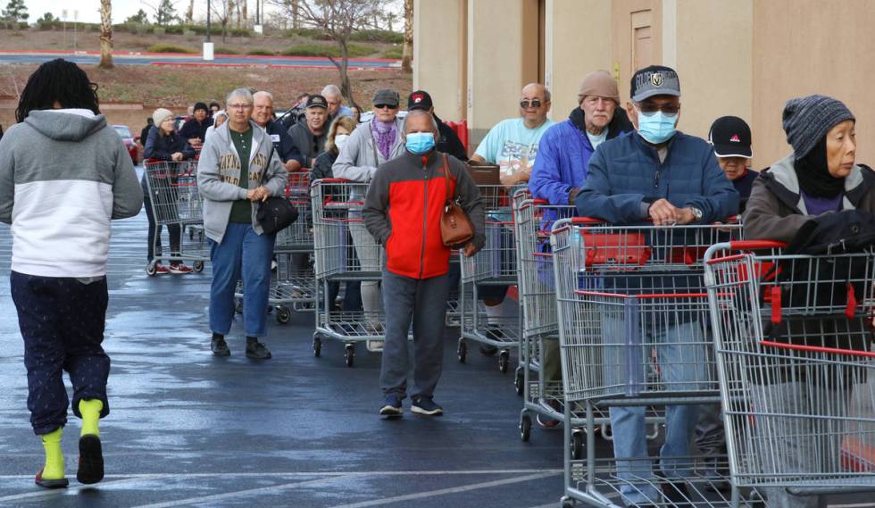 Seniors line up outside Costco on Friday, March 20, 2020, in Henderson. The store reserved earl ...